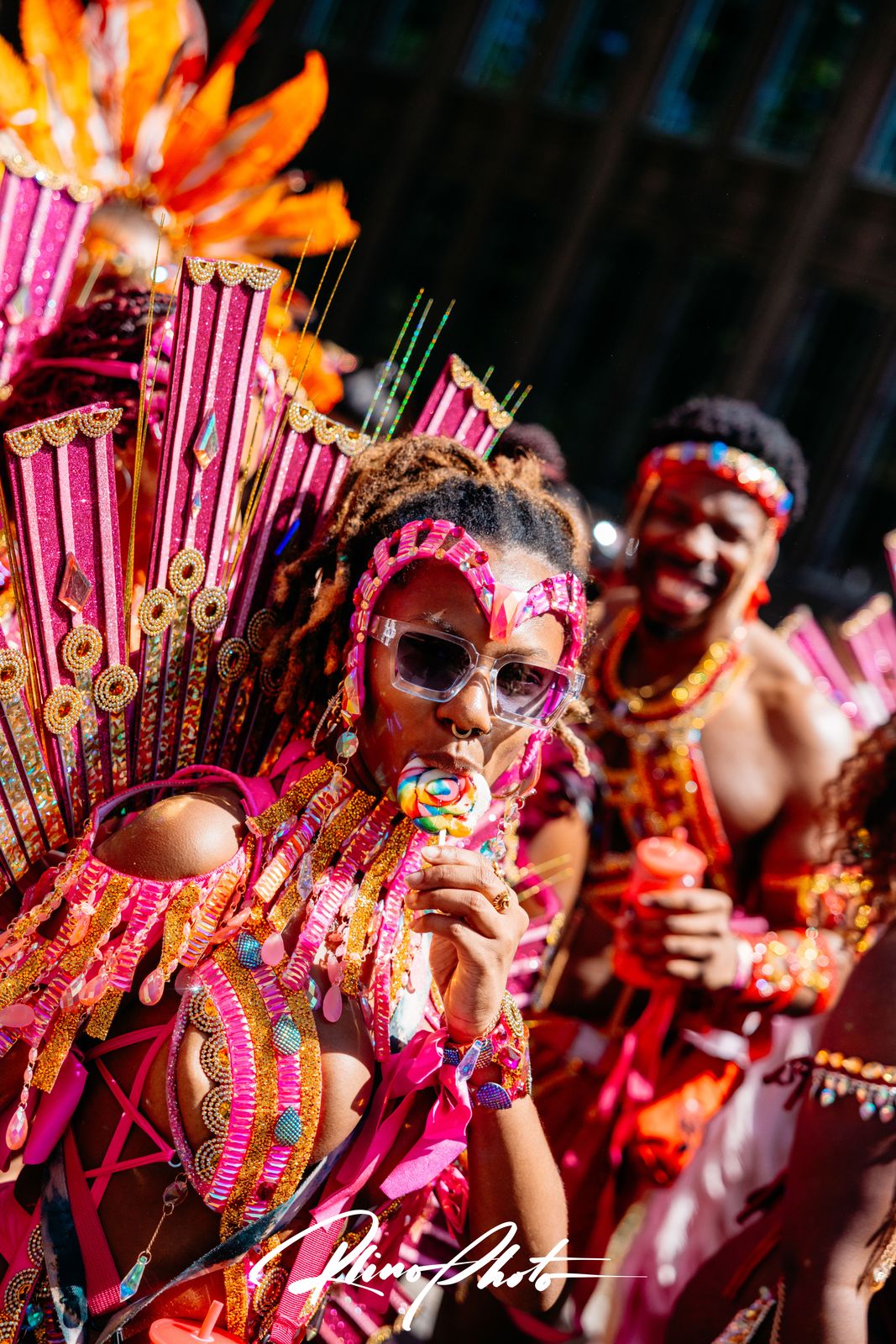 Carnival performer in a pink and gold feathered costume